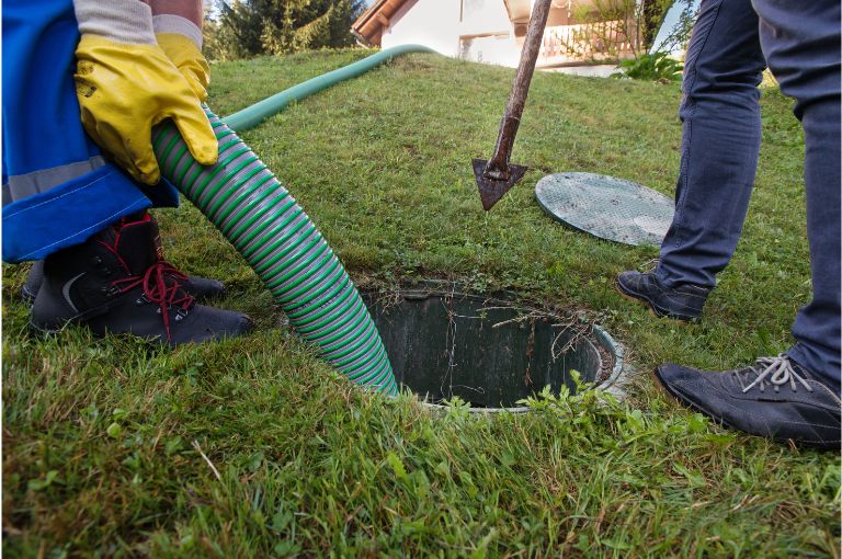 professional plumbers flush a sewer line